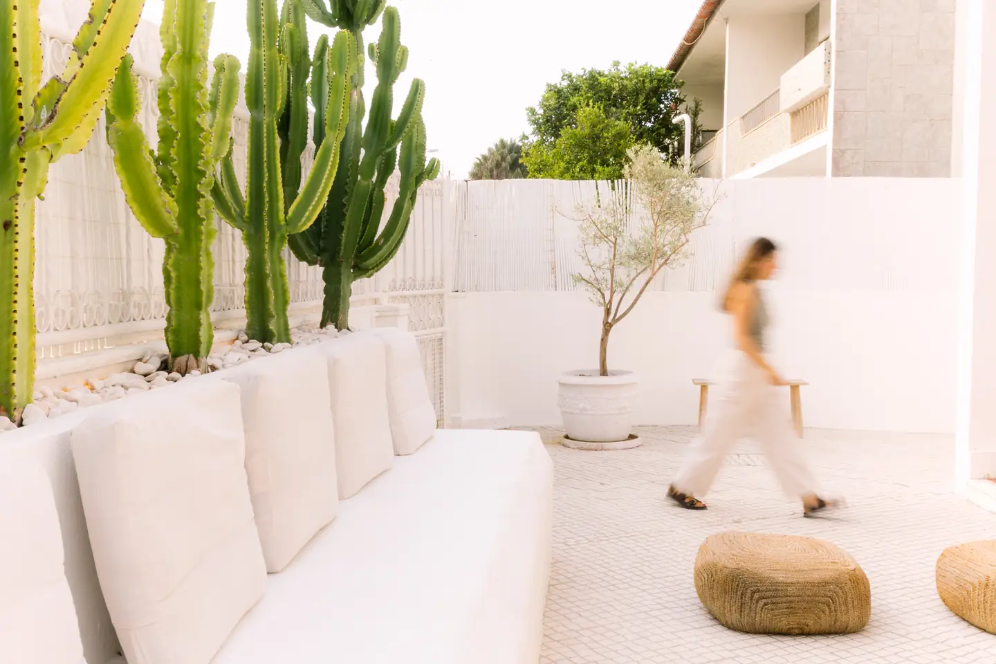 White built-in bench with cushions in the house's courtyard