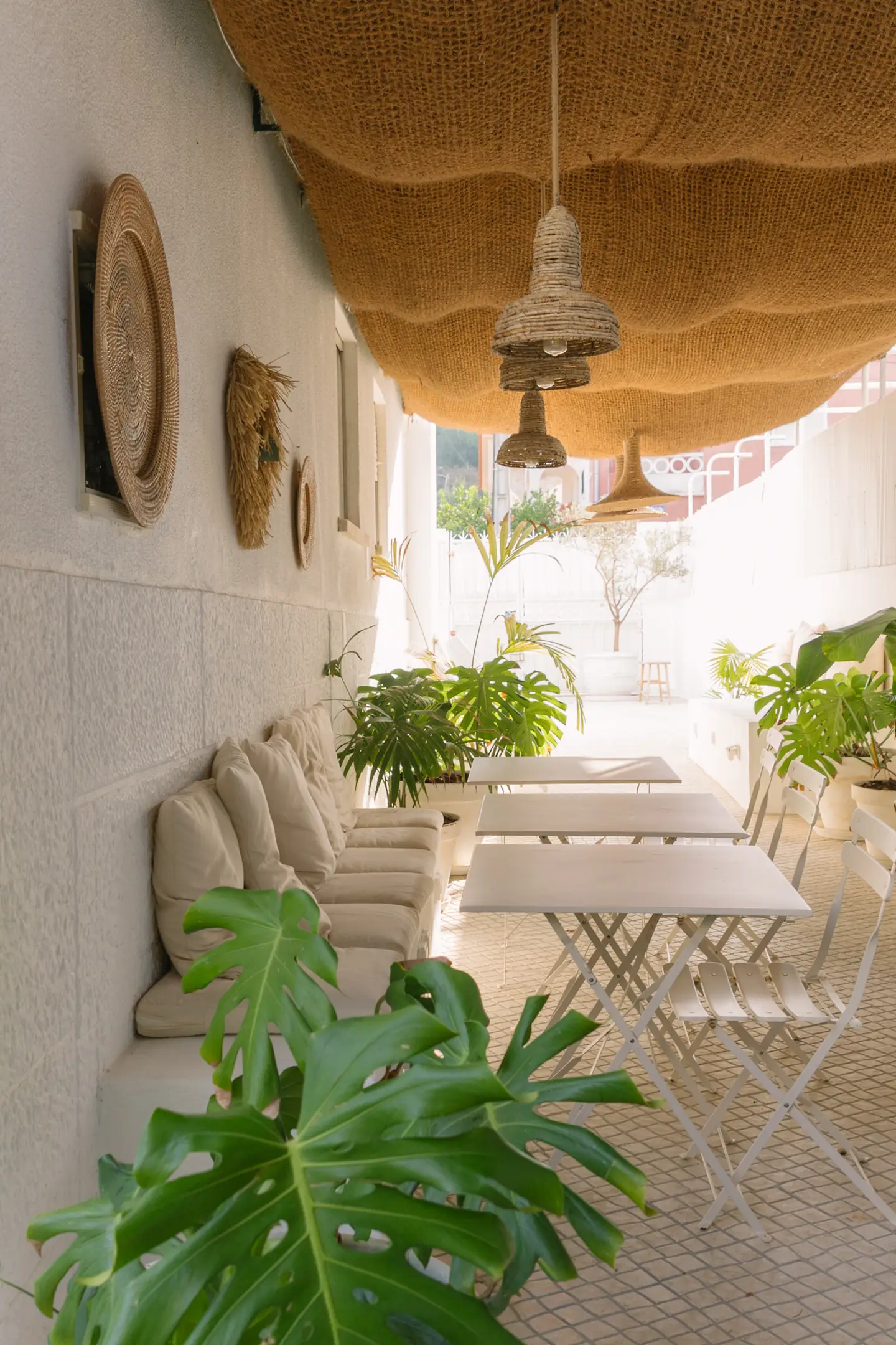 Outdoor gallery with plants and white arches
