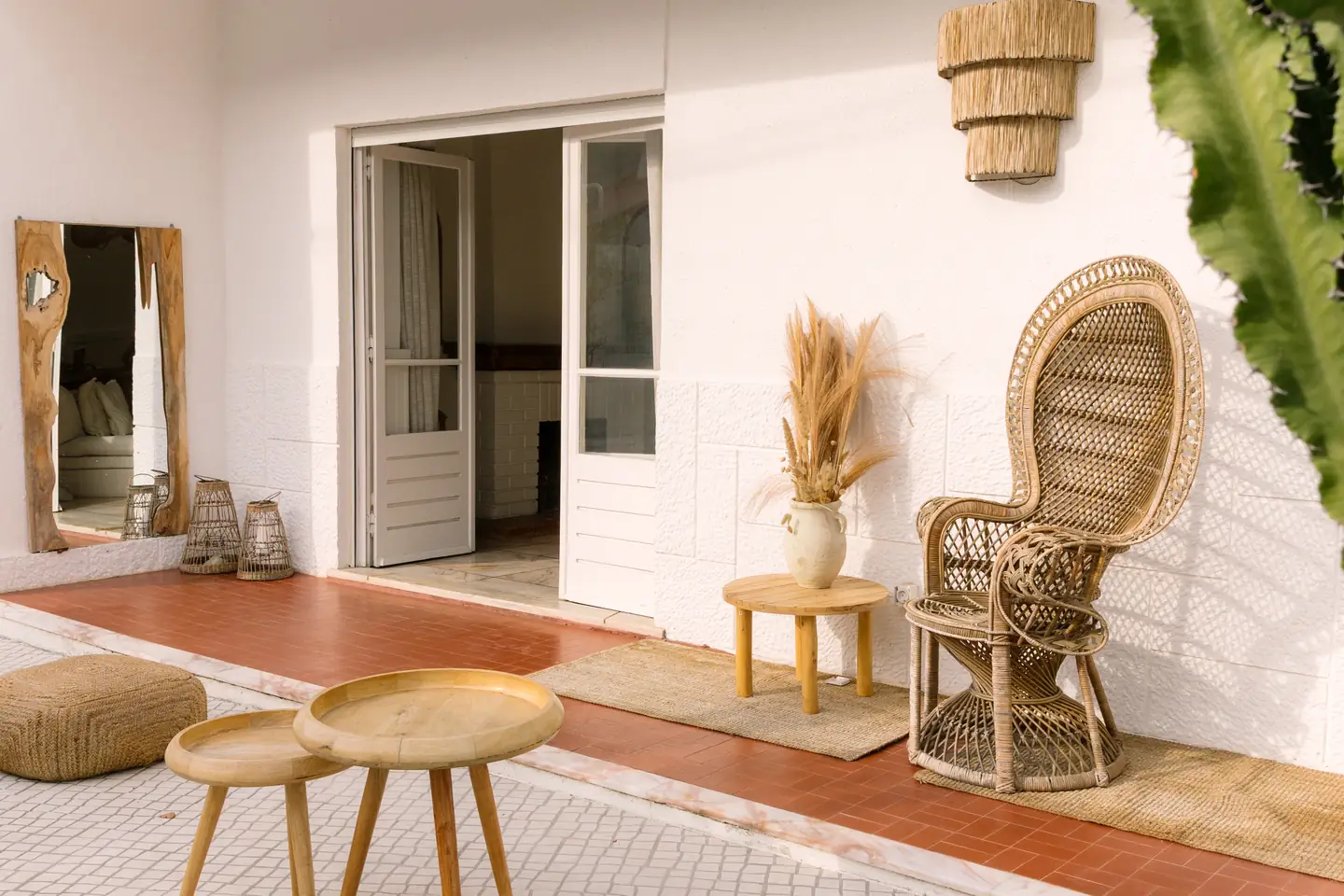 Terrace with wicker chairs and straw lamps at dusk