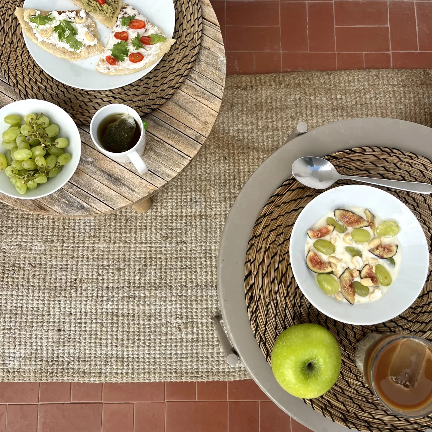 Breakfast seen from above, with fruit and tableware